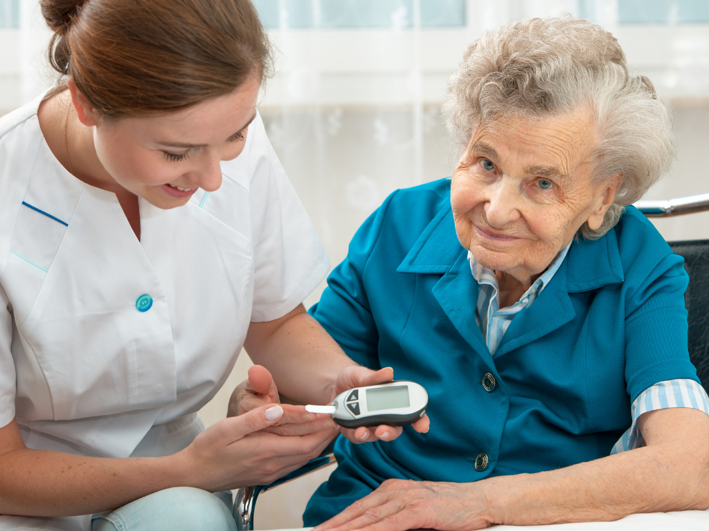 senior woman getting blood sugar level taken by young nurse